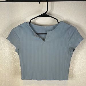 Cropped t-shirt with little v-neck slit.